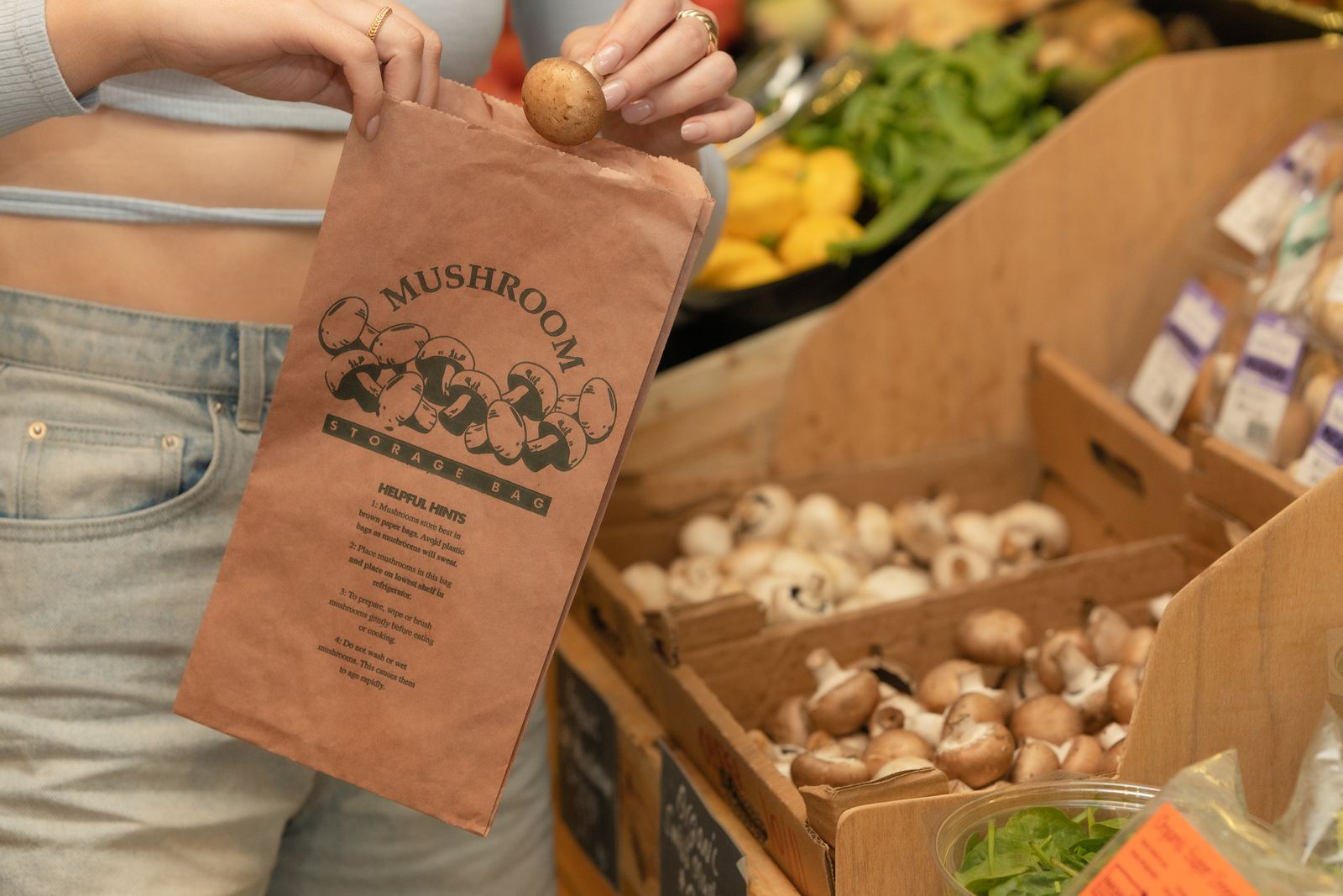 A paper mushroom bag being filled at a greengrocer
